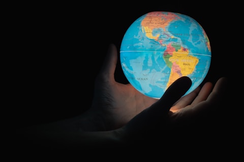 A glowing globe held in hands