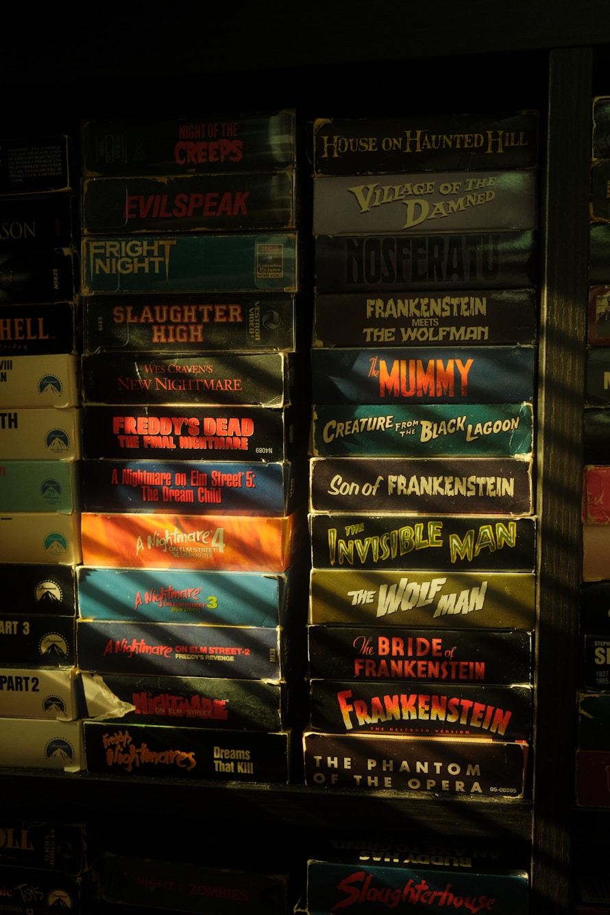 Vintage horror film shelves lit in red and amber